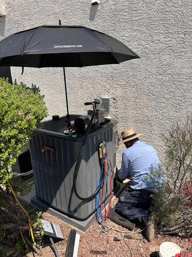 HVAC technician performing outdoor AC maintenance in Coppell